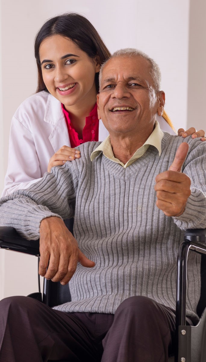 Professional caregiver assisting elderly patient at home in Dhaka, Bangladesh
